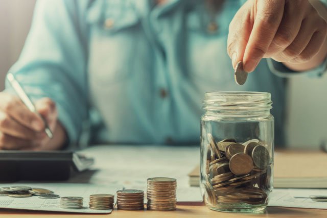 Man putting money into a business savings account