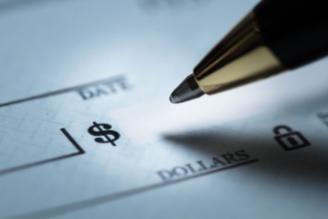 Person writing a check