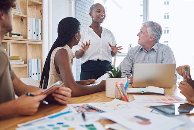 group of people sitting around a table having a meeting